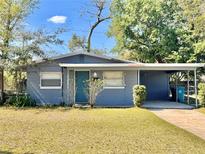 Charming single-story home with a blue exterior, covered carport, and well-maintained front yard at 544 S Cottage Hill Rd, Orlando, FL 32805