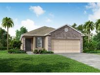 One-story home with stone accents and a two-car garage at 5599 Maddie Dr, Haines City, FL 33845