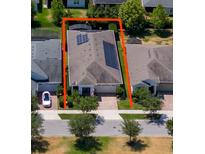 An aerial view of a single Gathering home with solar panels and manicured landscaping at 4904 W Fountainwood Dr, St Cloud, FL 34772