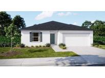 Charming single-story home featuring a two-car garage, a well-manicured lawn, and simple landscaping at 1445 General Mac Arthur Ave, Daytona Beach, FL 32114