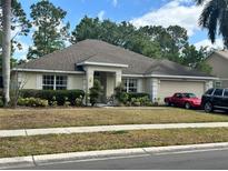 Charming single story home with a well-manicured lawn, attached two car garage and covered entryway at 1201 Thornbury Ct, Winter Garden, FL 34787