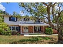 Two-story house with brick facade, new windows, and a spacious lawn at 965 Tuskawilla Rd, Winter Springs, FL 32708