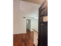 Inviting living room showcasing beautiful hardwood floors and modern lighting fixture at 5132 Conroy Rd # 937, Orlando, FL 32811