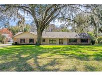 Ranch-style home with brick accents and a spacious lawn at 1126 Kelso Blvd, Windermere, FL 34786