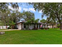 Charming single-story home with a well-manicured lawn and lush landscaping at 334 Terrace Dr, Oviedo, FL 32765