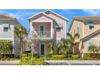 Pink two-story home with balcony, and well-manicured landscaping at 2956 Salted Rim Rd, Kissimmee, FL 34747