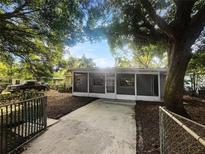 Charming single-story home with screened-in porch and mature trees in a quiet neighborhood at 122 Club Rd, Sanford, FL 32771