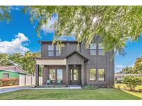 Beautiful two-story home featuring a modern farmhouse design with a well-manicured lawn and tasteful landscaping at 3480 Fairway Ln, Orlando, FL 32804