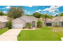 One-story house with attached garage and well-maintained lawn at 421 Paradise Woods Ct, Davenport, FL 33896