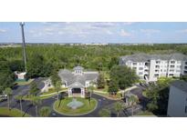 A beautiful community featuring a clubhouse, pool, and lush landscaping at 3176 Feltrim Pl # 305, Kissimmee, FL 34747