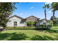 Single-story home with stone accents and lush landscaping at 32619 View Haven Ln, Sorrento, FL 32776