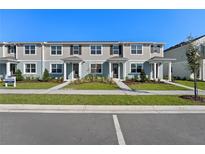 Newly built townhomes with modern exteriors, manicured lawns, and individual entryways at 3205 Douglas Fir Dr, Apopka, FL 32703