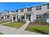 Charming townhouse with a well-manicured lawn and inviting entrance, perfect for modern living at 3225 Douglas Fir Dr, Apopka, FL 32703