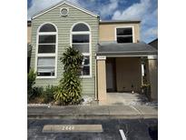 Two-story condo featuring large arched windows, a covered front porch, and designated parking at 2444 Summerfield Way # 1, Kissimmee, FL 34741