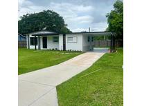 Charming single-story home with well-manicured lawn, carport, and freshly painted exterior at 2806 Bonneville Dr, Orlando, FL 32826