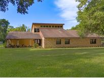 Sprawling single-story home featuring a brick facade, clerestory windows, and a well-maintained front lawn at 9525 Mcnorton Rd, Altamonte Springs, FL 32714