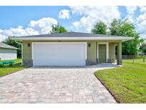 Charming single-story home with a brick paver driveway and an attached one-car garage at 2240 Center St, Sanford, FL 32771