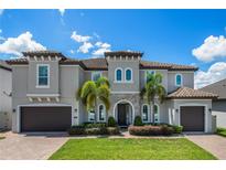 Stately two-story home featuring a beautiful stone entrance, two-car garage, and manicured lawn at 8300 Ludington Cir, Orlando, FL 32836