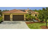 Two-story house with a tile roof, two-car garage, and landscaped yard at 729 San Raphael St, Kissimmee, FL 34759