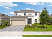 Charming two-story home featuring a landscaped front yard and a two-car garage at 2288 Sirena Ln, Mount Dora, FL 32757