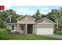 Charming single-story home features a two-car garage, manicured lawn, and blossoming flower beds at 2280 Sirena Ln, Mount Dora, FL 32757