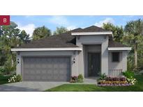 Charming single-story home featuring a gray exterior, well-manicured lawn, and a spacious two-car garage at 2284 Sirena Ln, Mount Dora, FL 32757
