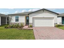 Charming single-story home with stone accents, brick driveway and a two-car garage at 4929 Kaia Ave, Winter Haven, FL 33884