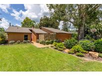 Charming single-story home with a well-maintained lawn, attractive landscaping, and mature trees at 4016 Salmon Dr, Orlando, FL 32835