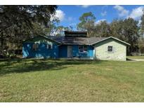 Charming single-story home with a spacious front yard and mature trees, ready for renovation at 1440 Walker Rd, Lakeland, FL 33810
