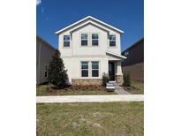 Charming two-story home features stone accents, neat landscaping, and an inviting covered entrance at 1227 Teal Creek Dr, Saint Cloud, FL 34771