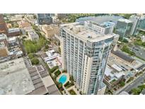 High-rise building boasts a sparkling pool surrounded by lush landscaping and city views at 155 S Court Ave # 1610, Orlando, FL 32801