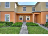 Charming townhome featuring a well-maintained lawn and inviting front entrance at 4032 Mountain Chestnut Way, Lakeland, FL 33812