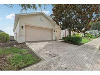 Charming home with a two-car garage and a brick paver driveway at 475 Windsor Pl, Davenport, FL 33896