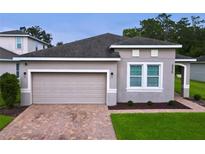One-story home with attached garage and landscaped lawn at 3225 Stratton Cir, Kissimmee, FL 34744