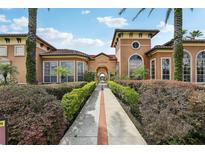 Beautiful clubhouse with palm trees and attractive landscaping, perfect for community gatherings and resident activities at 5530 Metrowest Blvd # 9-311, Orlando, FL 32811