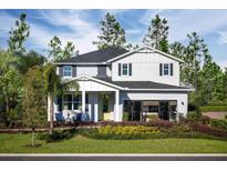 Two-story home featuring a meticulously landscaped front yard and charming architectural details at 2424 Park Ridge St, Apopka, FL 32712
