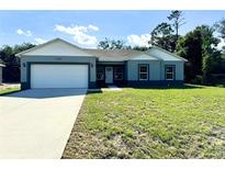 Charming single-story home featuring a two-car garage and a well-maintained lawn at 1209 Alafia Way, Poinciana, FL 34759