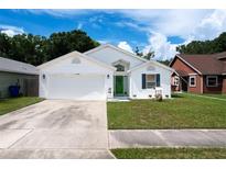 Charming single-story home featuring a well-maintained lawn, two-car garage, and bright green front door at 4316 Natchez Trace Dr, St Cloud, FL 34769