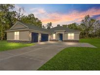 New three-car garage home with landscaped lawn at 13455 Sw 85 Pl, Dunnellon, FL 34432