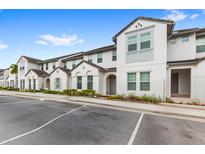 Front view of townhouses with parking and landscaping at 154 Captiva Dr, Davenport, FL 33896