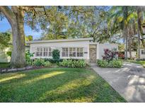 Charming mid-century home with landscaped lawn and driveway at 1410 Yates St, Orlando, FL 32804