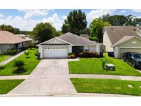 Cute one-story house with a two-car garage and well-manicured lawn at 2906 Woodruff Dr, Orlando, FL 32837