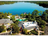 Aerial view of community amenities including pool, lake, and clubhouse at 113 Rogues Retreat, Davenport, FL 33897