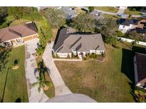 Aerial view of single-Gathering home with driveway and landscaped yard at 13707 Calle De Ora Ct, Clermont, FL 34711