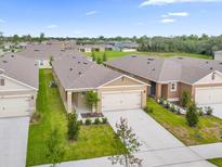 A beautiful home featuring a well-manicured lawn and an attached two-car garage at 957 King Parc Rd, Orange City, FL 32763