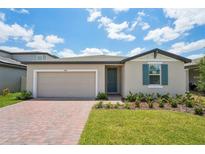 Charming single-story home featuring a brick driveway, lush lawn, and coordinated exterior paint scheme at 3824 Giorgio Dr, Winter Haven, FL 33884