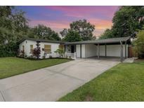Charming home featuring a carport, landscaped yard, and a freshly painted exterior at 2524 Dellwood Dr, Orlando, FL 32806
