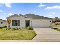 Charming one story home featuring a two car garage, a simple and well manicured front yard, and neutral paint at 3409 Narrows Dr, Lakeland, FL 33810