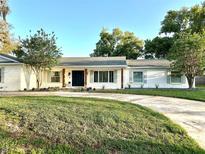 Charming one-story home with freshly painted white brick and a well-manicured lawn at 137 Variety Tree Cir, Altamonte Springs, FL 32714