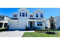 Charming two-story home featuring a landscaped yard, a two car garage, and neutral exterior paint at 1189 Basalt Ln, Sanford, FL 32771